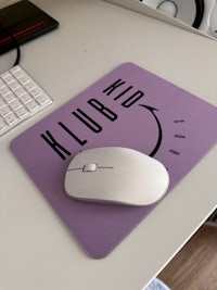 a mouse pad on a desk with a keyboard and mouse