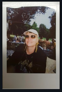 a photo of a woman wearing sunglasses and a hat